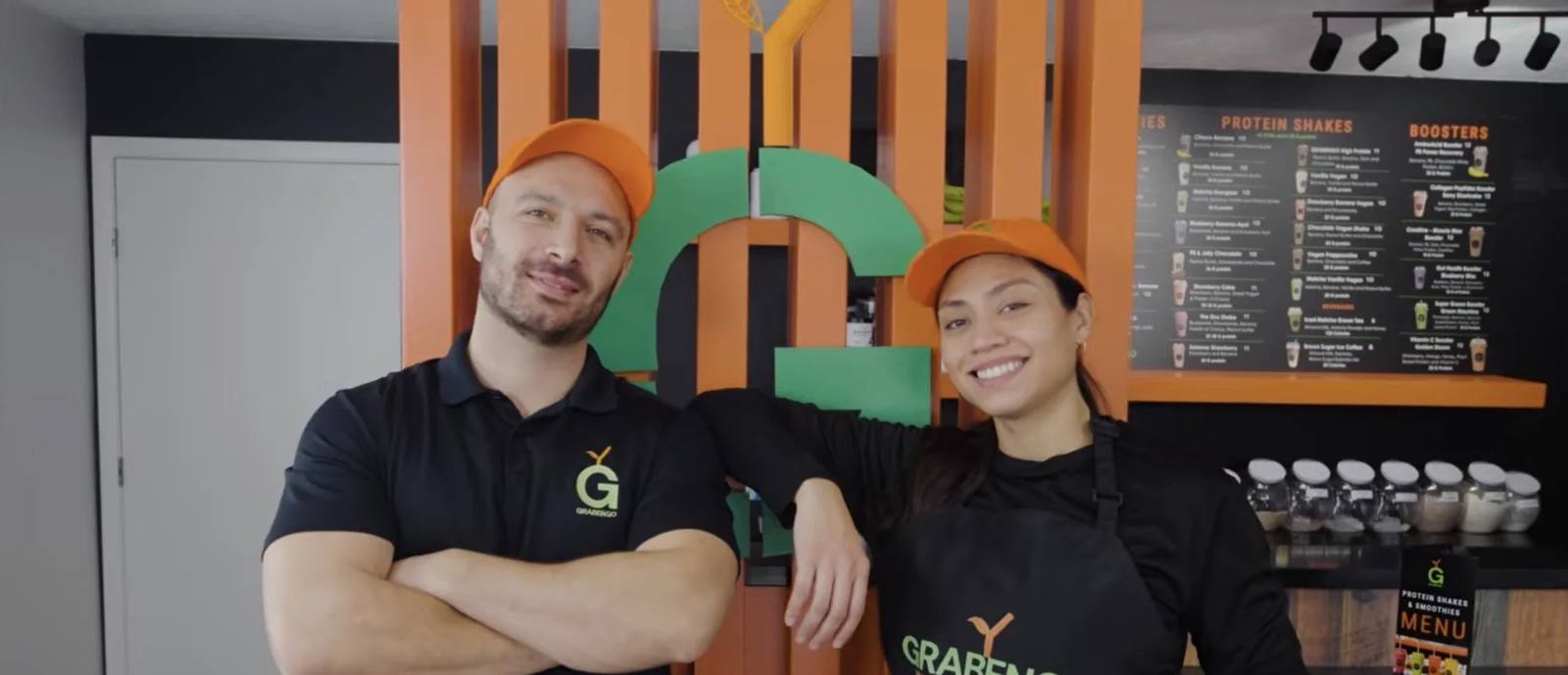 Inside Grabengo: the tall orange-slat G wall and the menu board behind the counter
